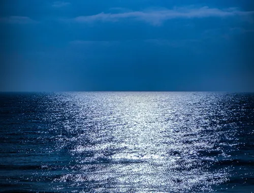 Ultra-bright sea, large body of water illuminated as if it were silver paper