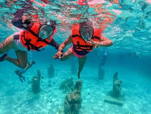 Explore the vibrant underwater world near Isla Mujeres! Snorkel through the unique statues of an underwater museum and discover the marine life on your epic Spring Break Party Catamaran tour.