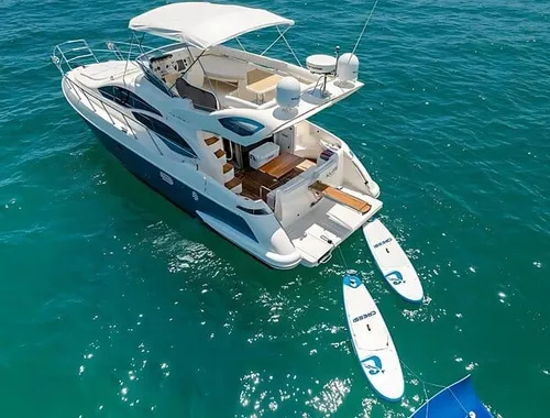Enjoy water toys like paddleboards from the spacious swim platform of your private yacht.