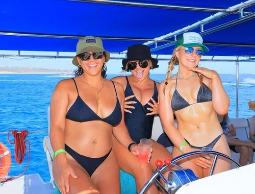 Cheers to Cabo! Pose with your drinks and friends on the front of the party catamaran, featuring an open bar and music.