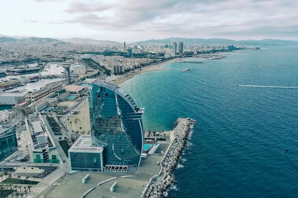 Aerial view of the Barcelona coast and the W hotel at Port Olímpic. Photo via Unsplash