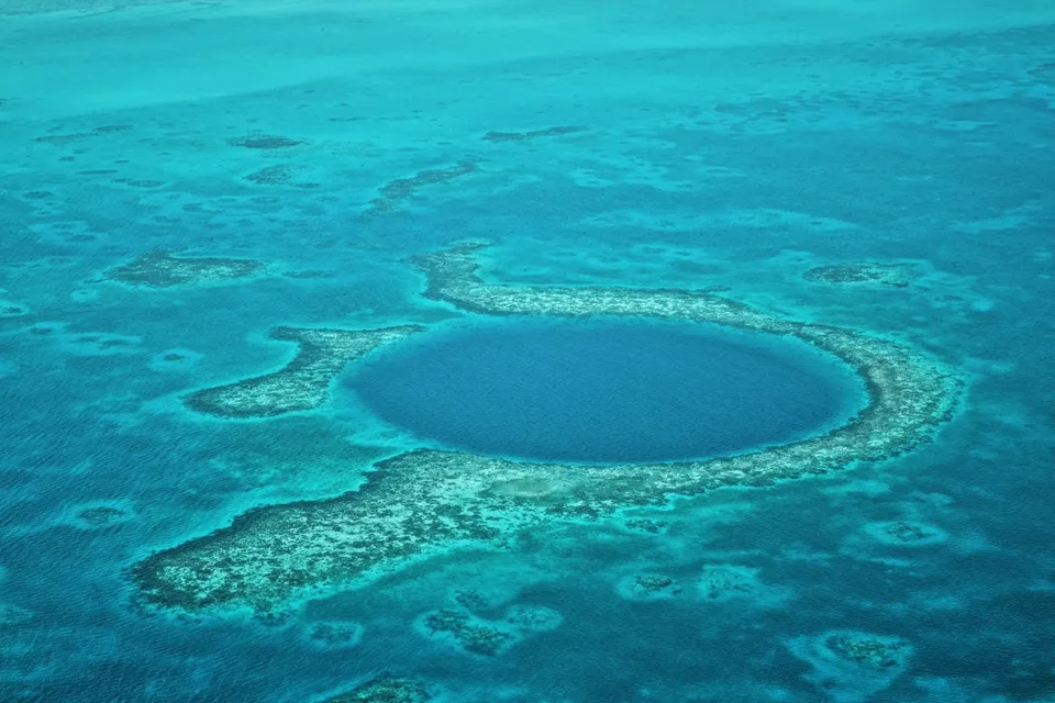 Aerial view of the Great Blue Hole in Belize. Photo via Unsplash
