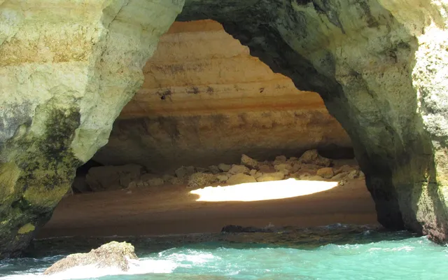 Entrance of Benagil Cave seen from the sea, with light coming through the roof