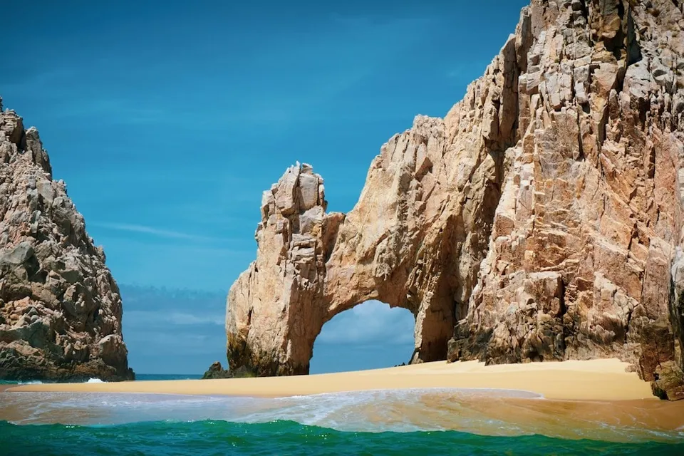 Rock formations in the sea at Cabo San Lucas. Photo via Unsplash
