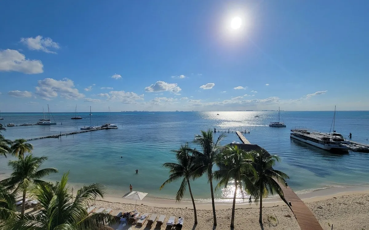Palm-lined beach and boats on the Cancún coast