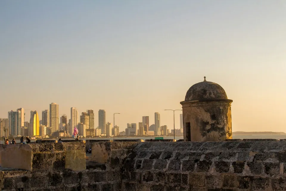 The old stone walls of Cartagena with the modern skyline behind. Photo via Unsplash