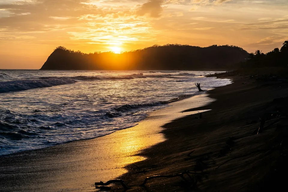 A sunset on the Pacific coast of Costa Rica. Photo via Unsplash