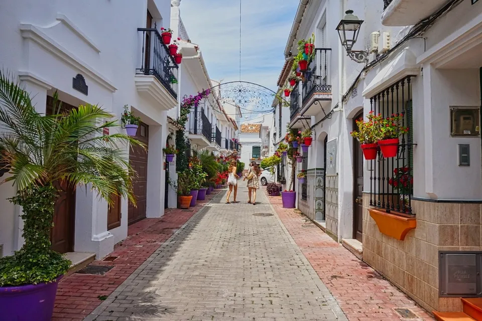 A whitewashed street with flowerpots in Estepona old town. Photo via Unsplash