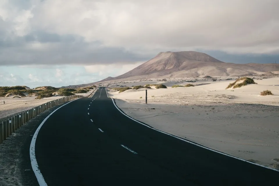 Road through the dunes and volcanic hills of Fuerteventura. Photo via Unsplash
