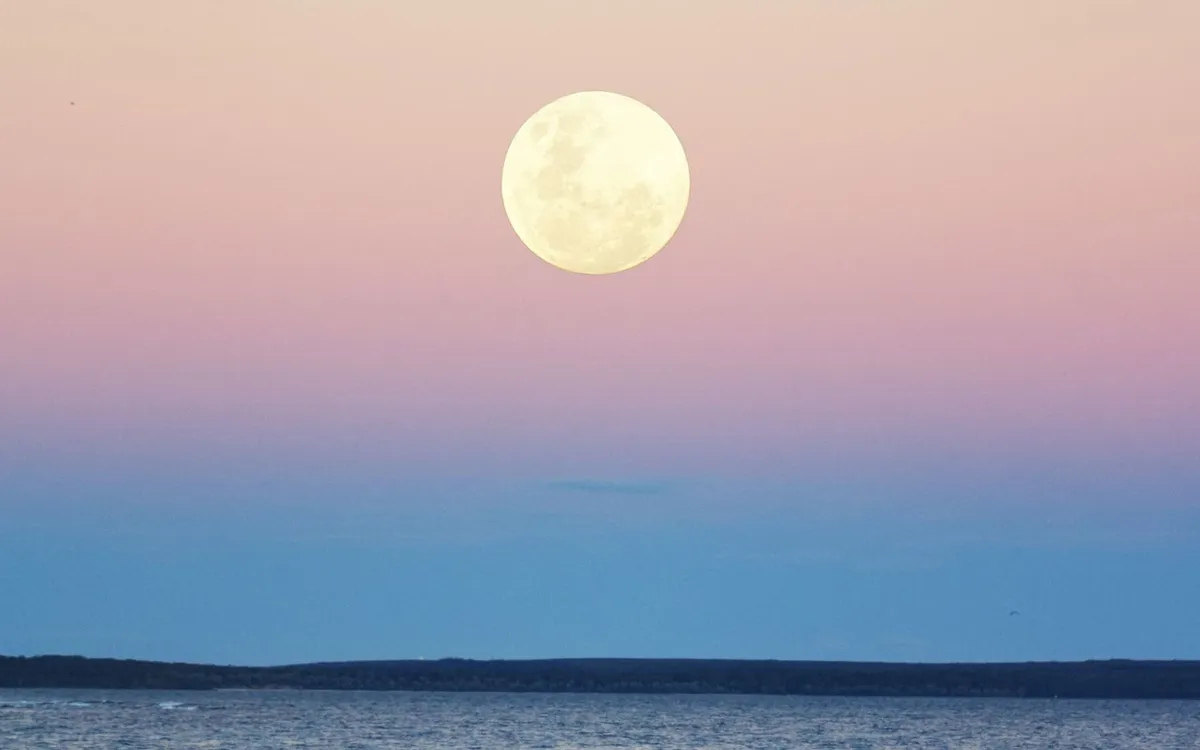 Full moon rising over the sea