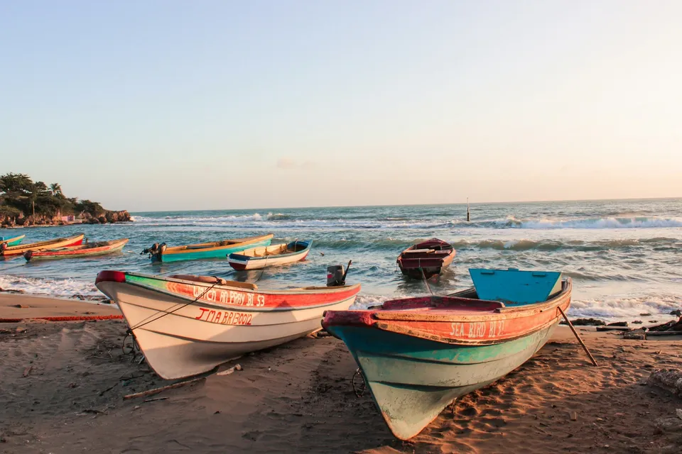 Traditional fishing boats on a beach in Jamaica. Photo via Unsplash