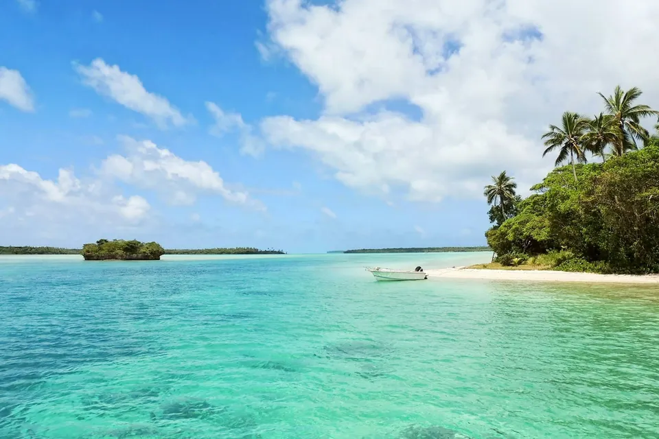 Turquoise water and a tropical island in Jamaica. Photo via Unsplash