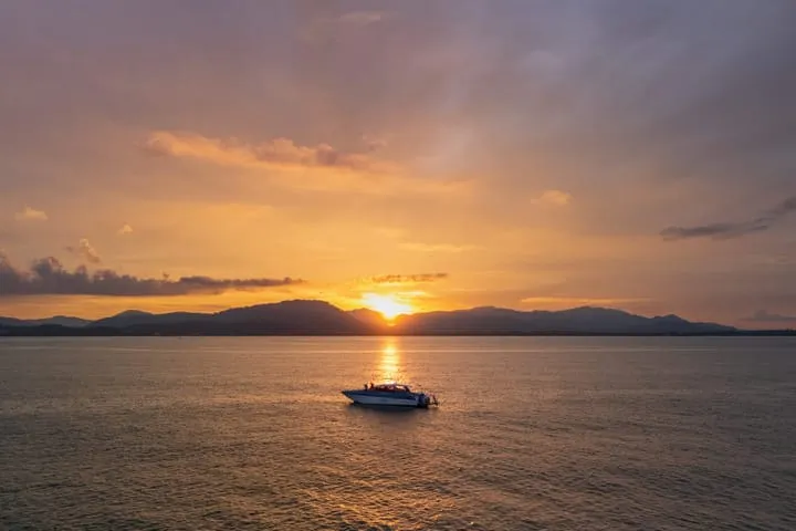A speedboat at sunset over the Andaman Sea near Phuket