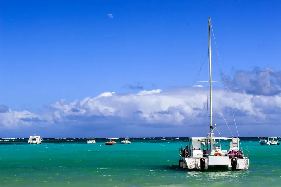 Catamaran sailing off a Punta Cana beach. Photo via Unsplash