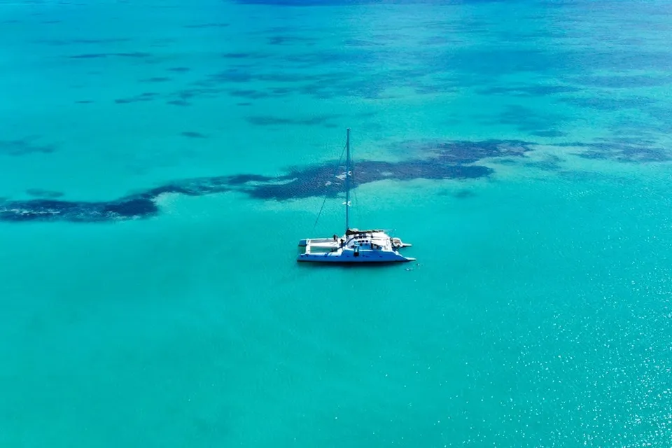 Aerial view of a catamaran on turquoise water near Punta Cana. Photo via Unsplash