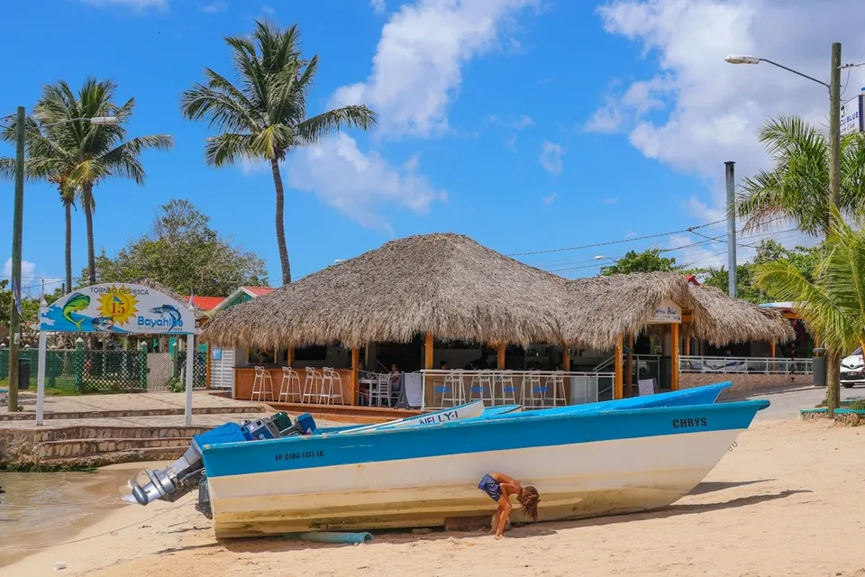 Beach bar and fishing boat on a Caribbean beach in the Dominican Republic. Photo via Unsplash