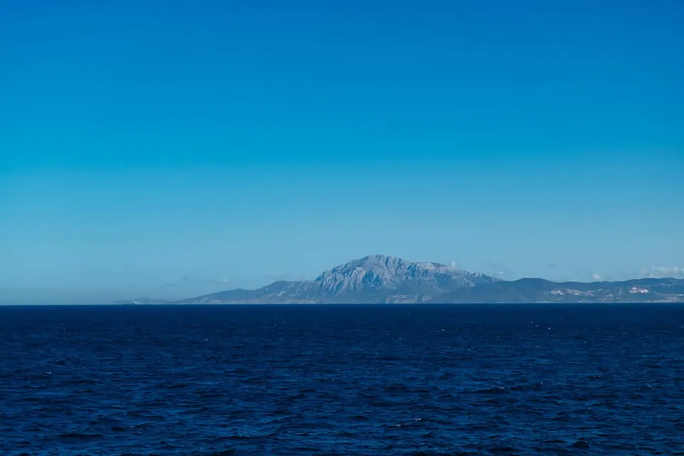 The Strait of Gibraltar seen from the sea, with the Rock in the distance. Photo via Unsplash