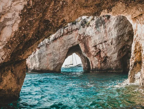 Sailboat seen through an arch of the Blue Caves, Zakynthos