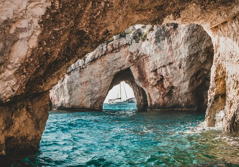 Sailboat seen through an arch of the Blue Caves, Zakynthos