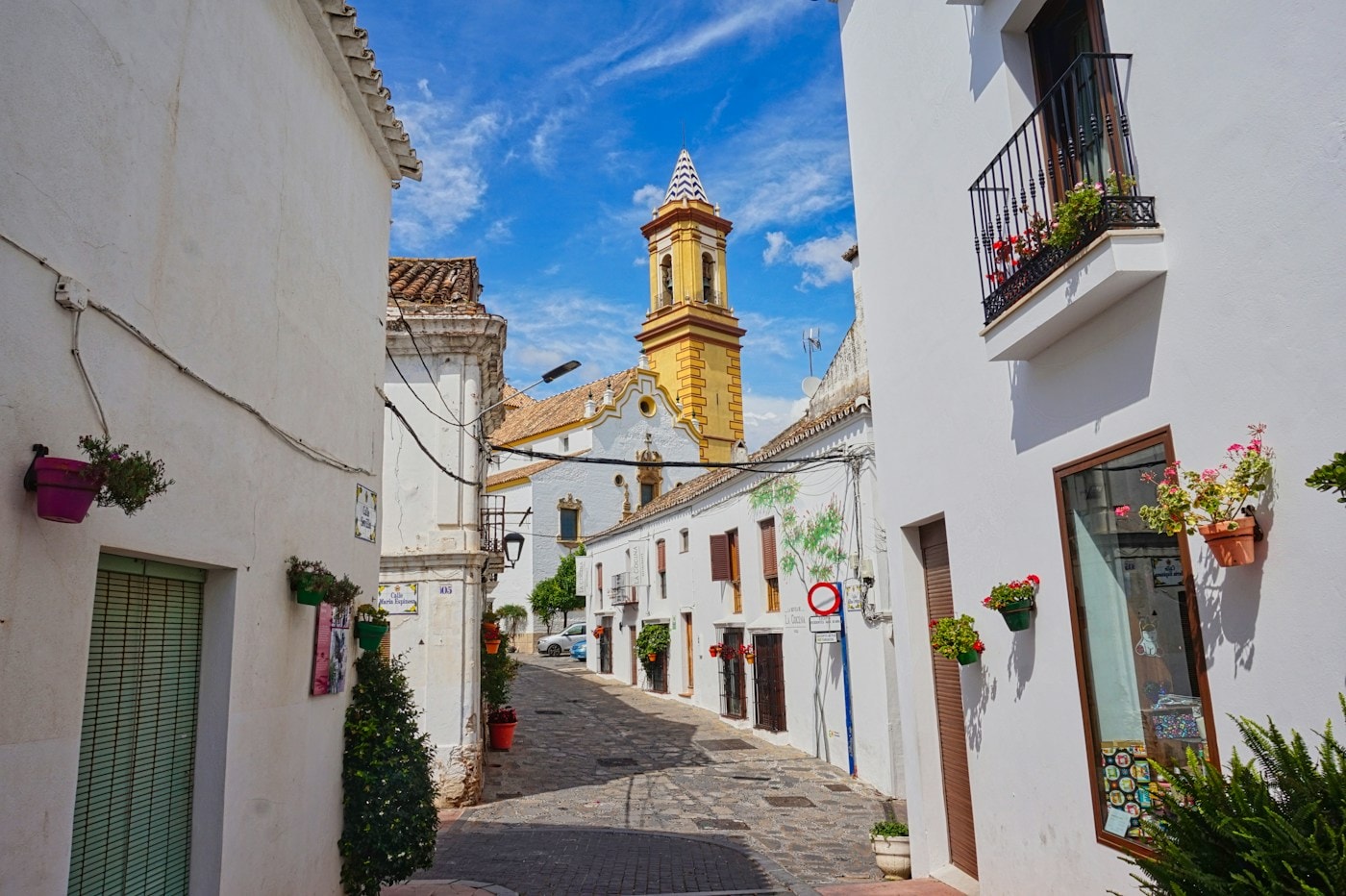 Street in Estepona old town with the clock tower in the background