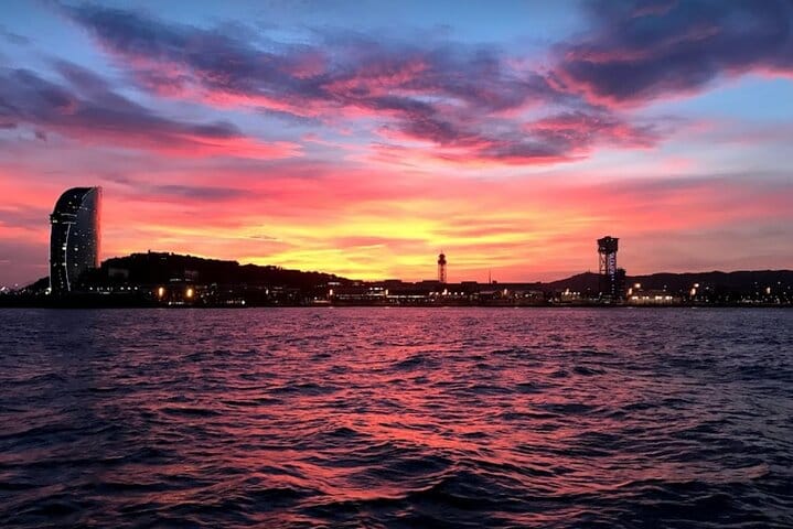 Sunset over the Barcelona coastline, seen from the water