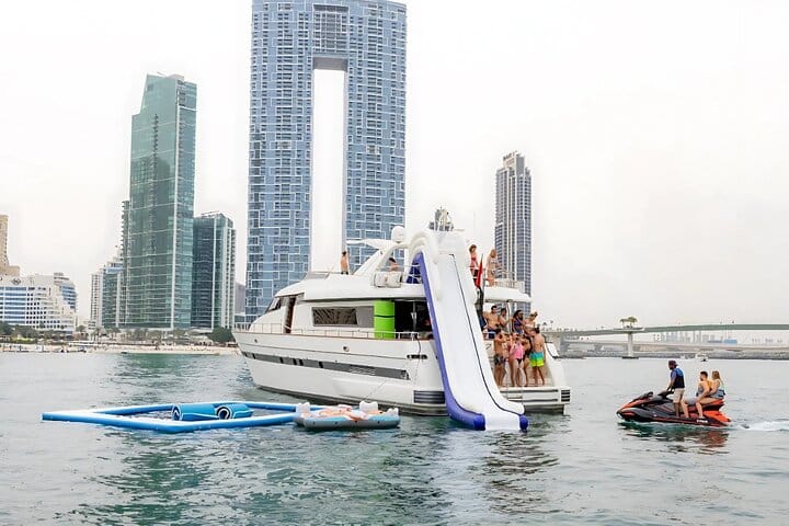 A yacht with a slide and a floating pool, on the slide and pool cruise