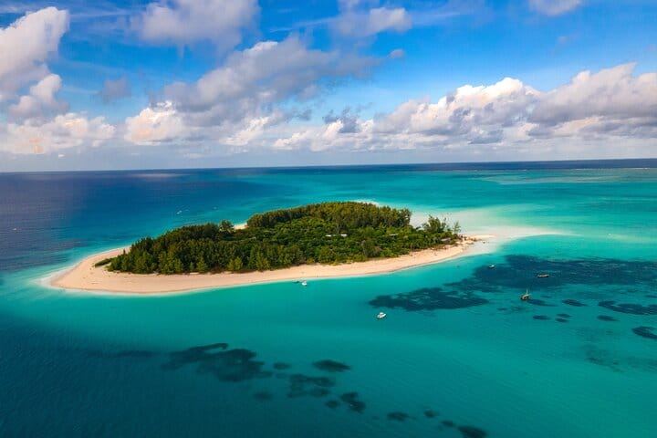 A small island ringed by sand and clear water (photo from the Mnemba listing)